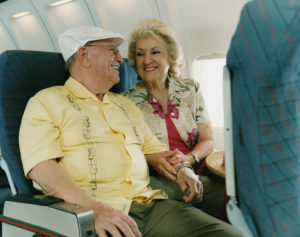 Senior Couple Smiling at Each Other on a Plane