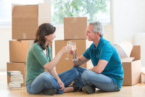Mature Couple Toasting Champagne Flutes In New House