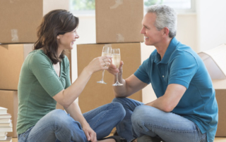 A couple in their 60s celebrating over wine after decluttering
