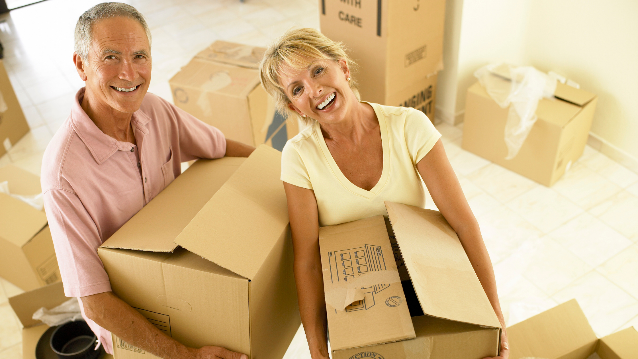 a couple in their 60s downsizing their home with moving boxes