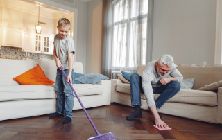 An image of a grandfather and his grandson organizing and decluttering home.
