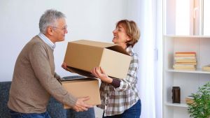 A husband and wife decluttering their home to get ready for downsizing.