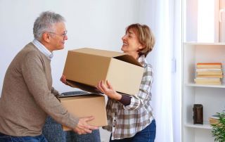 A husband and wife decluttering their home to get ready for downsizing.