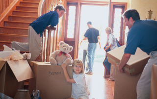An image of family moving from their big house to a smaller, more manageable home taking only what they need and love.