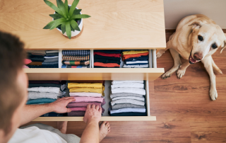 A man organizing and decluttering one drawer at a time.