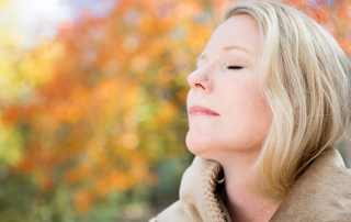 An image of a baby boomer woman who found peace in a new minimalist lifestyle while downsizing her home.