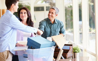 An image of a couple decluttering their stuff with their son to make sure he gets what he would like to bring home with home from his parent's house.