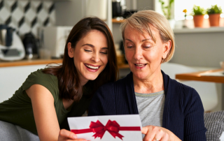 An image of a daughter gifting her mother the gift of shared experience making sure they create new memories together this holiday season the minimalist way.