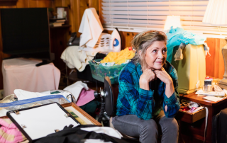 An image of a middle aged woman looking at all the clutter that has creeped back at her home after decluttering.