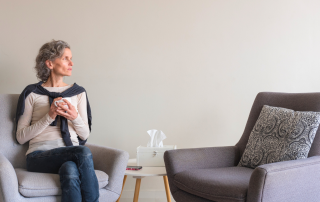 An image of a baby boomer woman who is scared to leave her things behind and the memories they have.