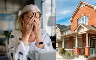 Woman over 60 covering her face in stress next to large suburban home representing feeling stuck in a paid-off house.