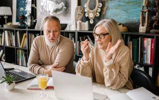Baby boomer couple exploring technology at home, symbolizing lifelong learning and embracing new digital opportunities.